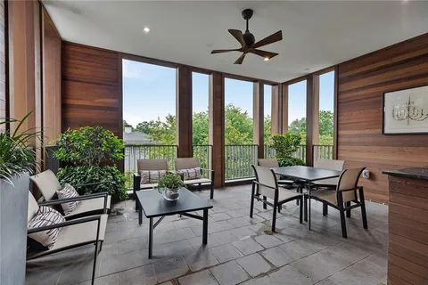 a dining room with furniture and a floor to ceiling window