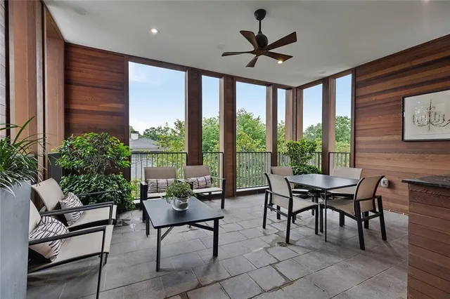 a dining room with furniture and a floor to ceiling window