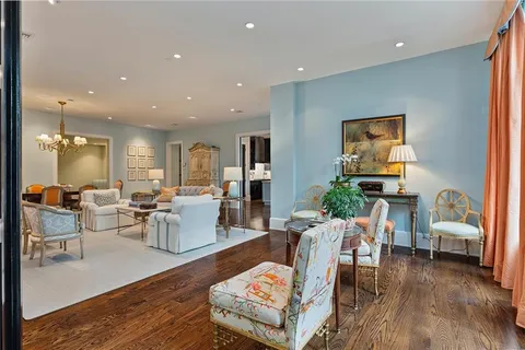a living room with lots of furniture and view of kitchen