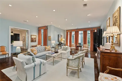 a living room with furniture and large windows