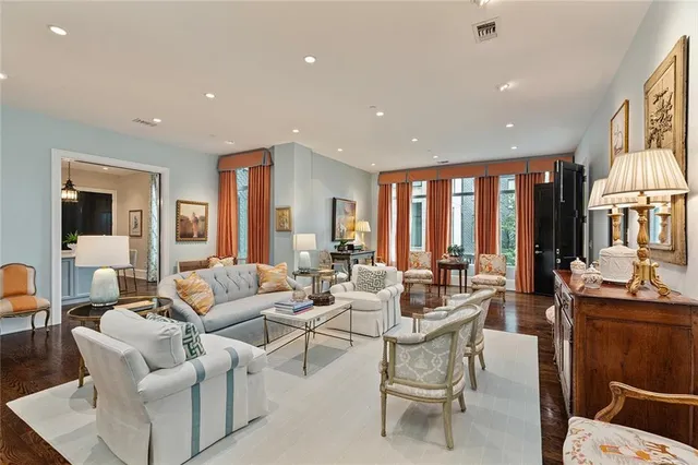 a living room with furniture and large windows