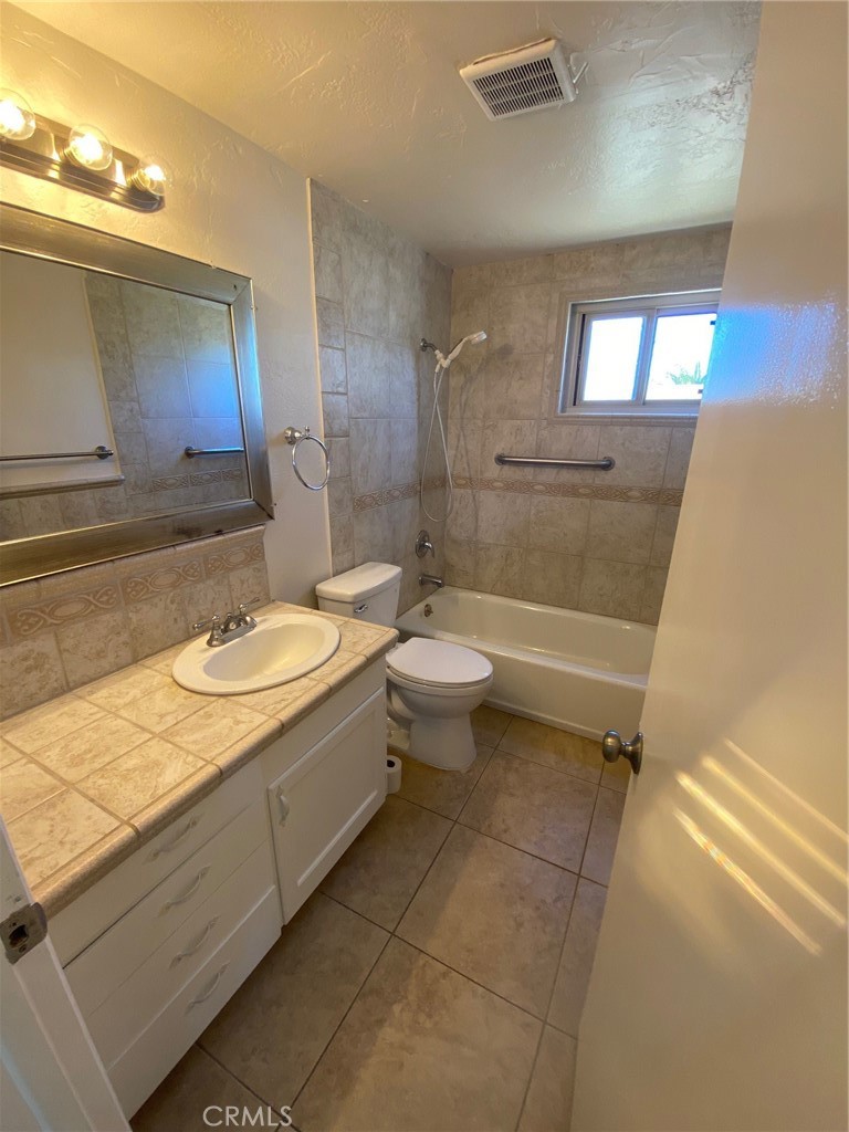 930 Orpheus Avenue, Unit A Encinitas, CA 92024 - Photo 12 of 18 a bathroom with a double vanity sink toilet mirror and bathtub