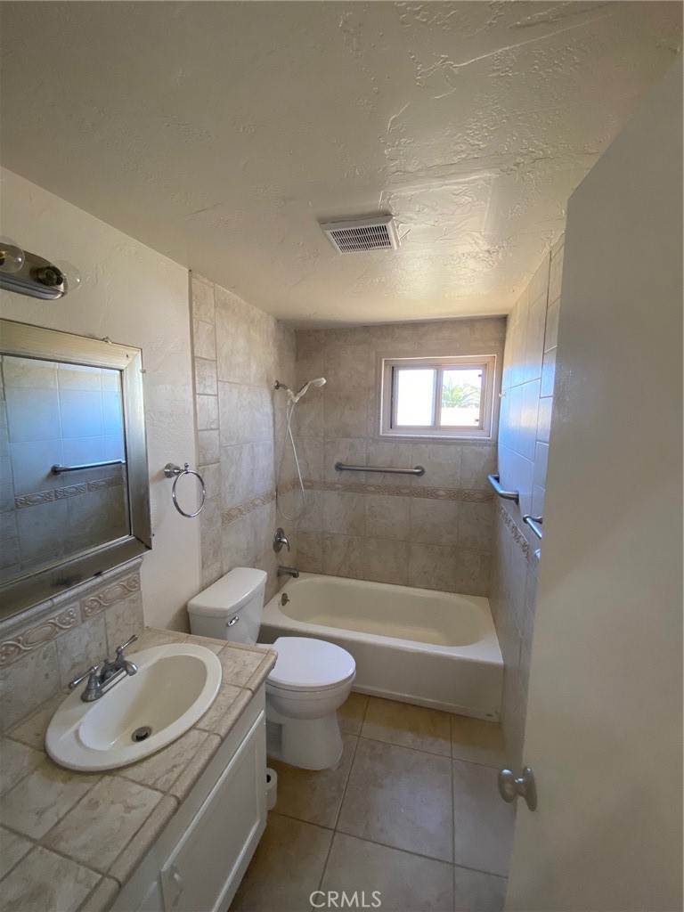 930 Orpheus Avenue, Unit A Encinitas, CA 92024 - Photo 13 of 18 a bathroom with a sink a toilet and bathtub