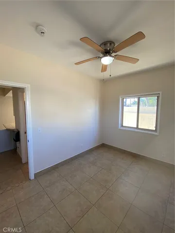 an empty room with a empty space and a ceiling fan
