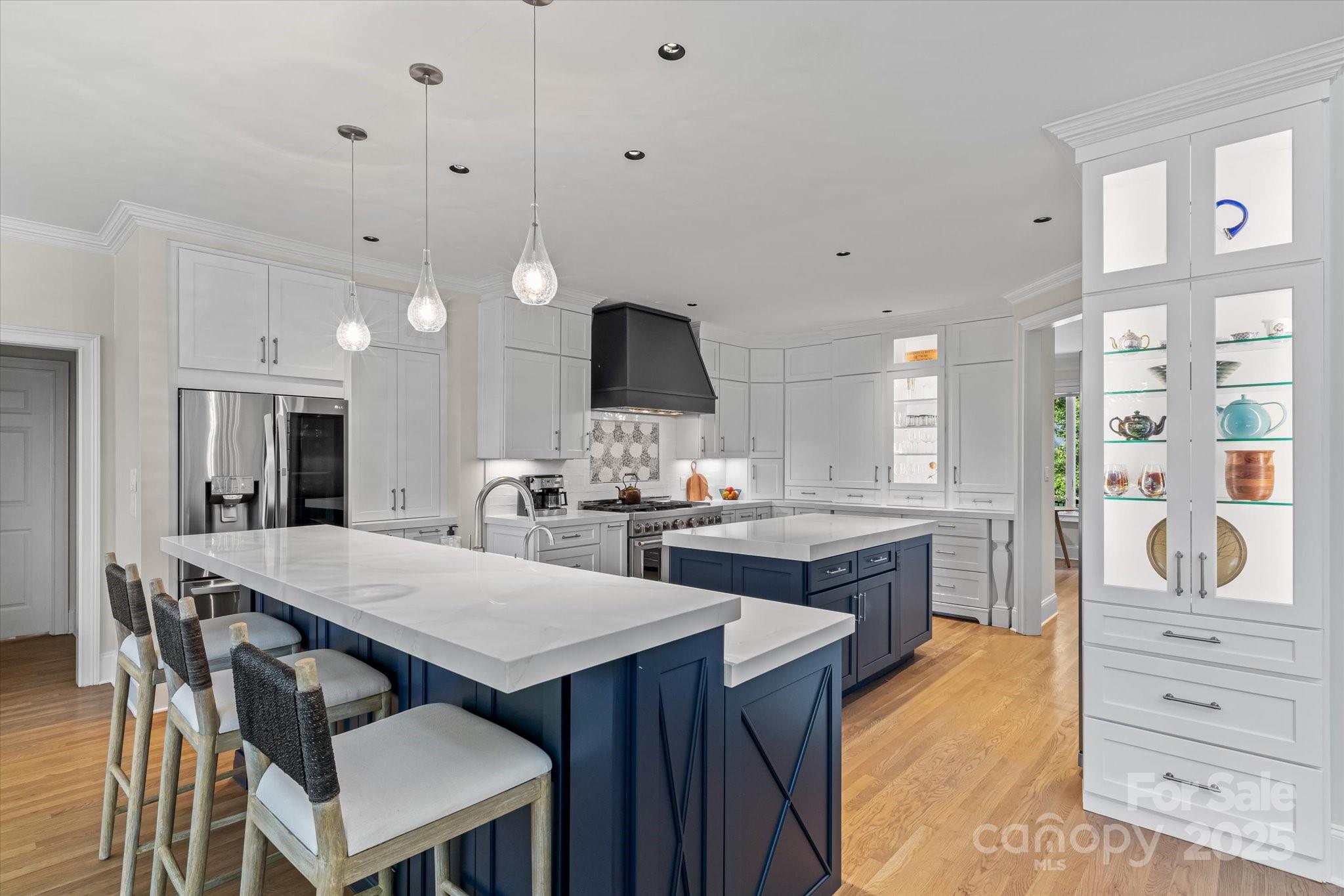 18916 Riverwind Lane Davidson, NC 28036 - Photo 11 of 38 a kitchen with granite countertop a stove a sink a dining table and chairs