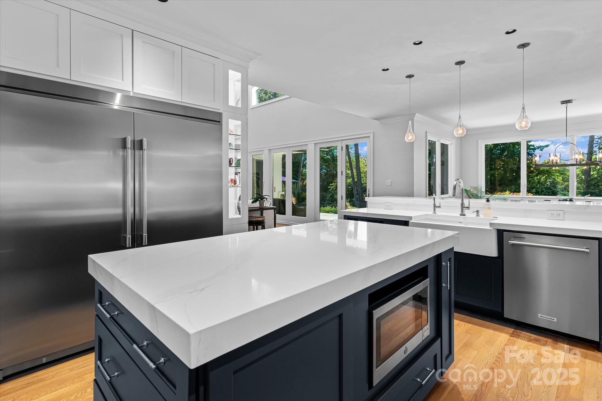 18916 Riverwind Lane Davidson, NC 28036 - Photo 12 of 38 a kitchen with kitchen island a sink stove and refrigerator