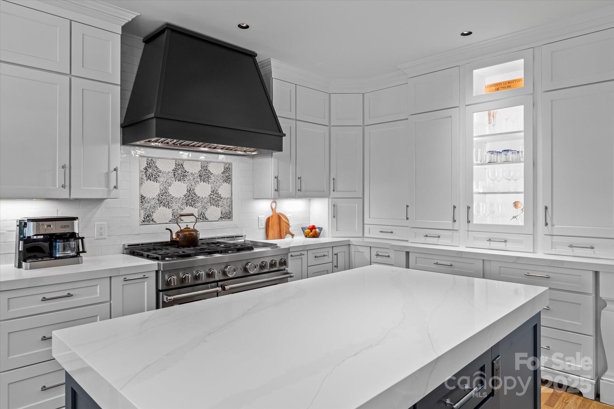 18916 Riverwind Lane Davidson, NC 28036 - Photo 14 of 38 a kitchen with granite countertop a sink a stove and cabinets