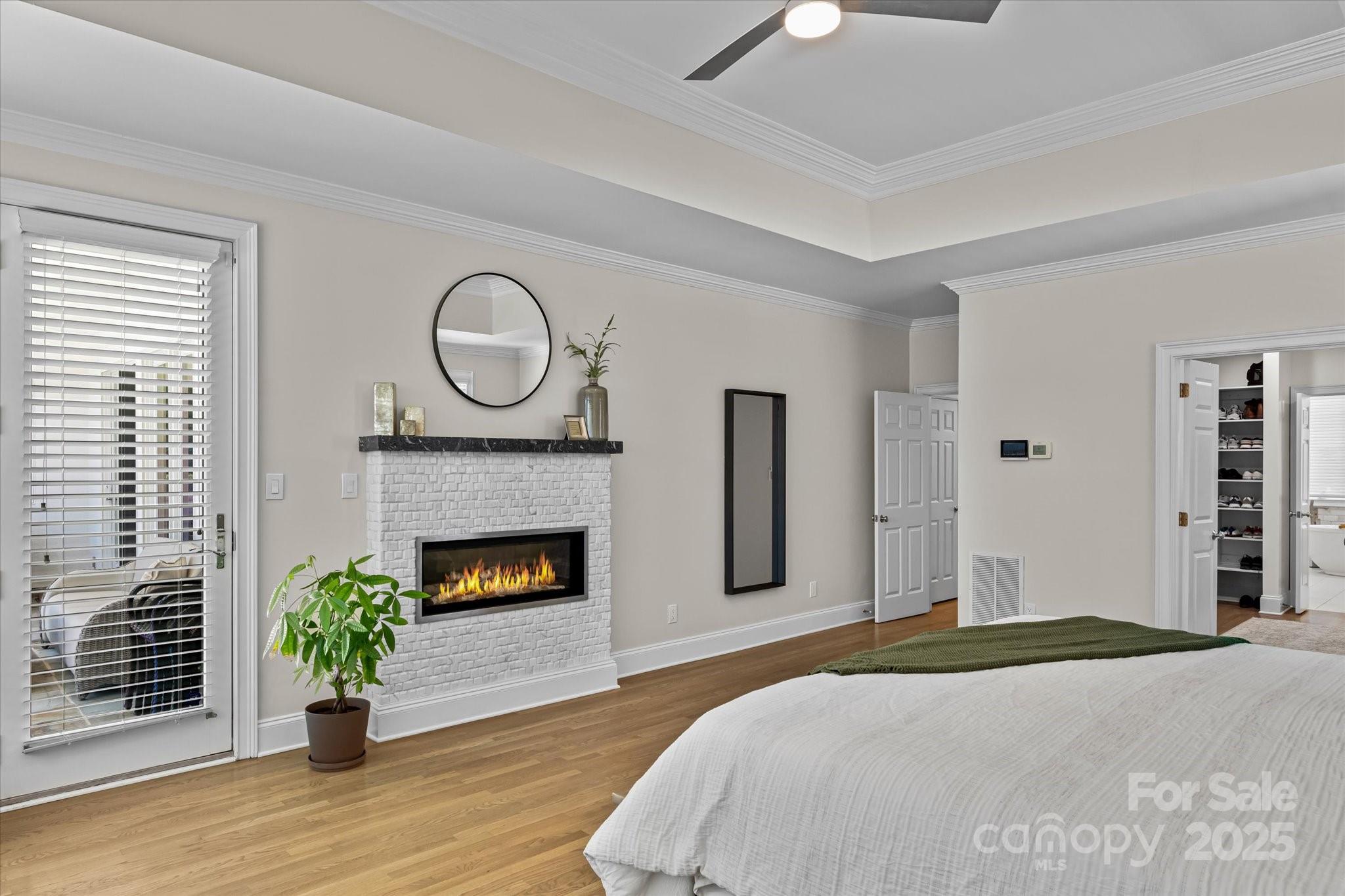 18916 Riverwind Lane Davidson, NC 28036 - Photo 18 of 38 a bedroom with a bed and a fireplace