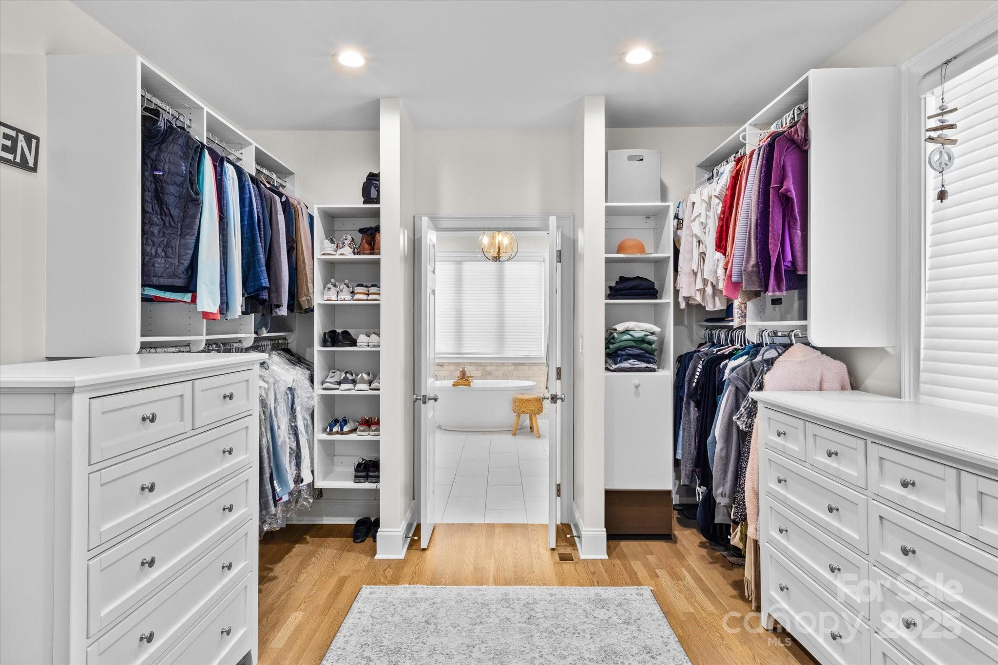 18916 Riverwind Lane Davidson, NC 28036 - Photo 19 of 38 a view of walk in closet with clothes and shoes