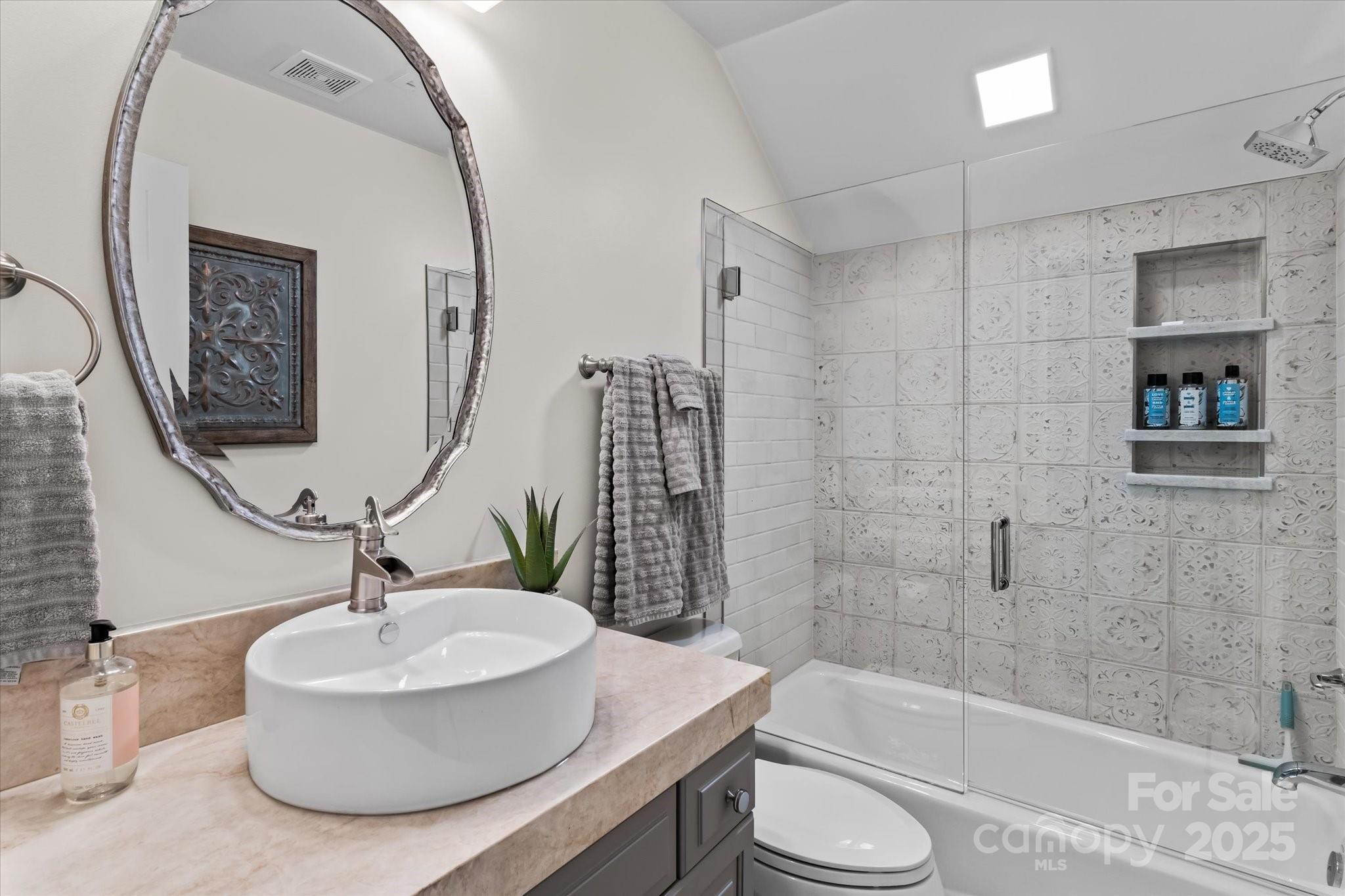 18916 Riverwind Lane Davidson, NC 28036 - Photo 26 of 38 a bathroom with a sink a toilet and shower