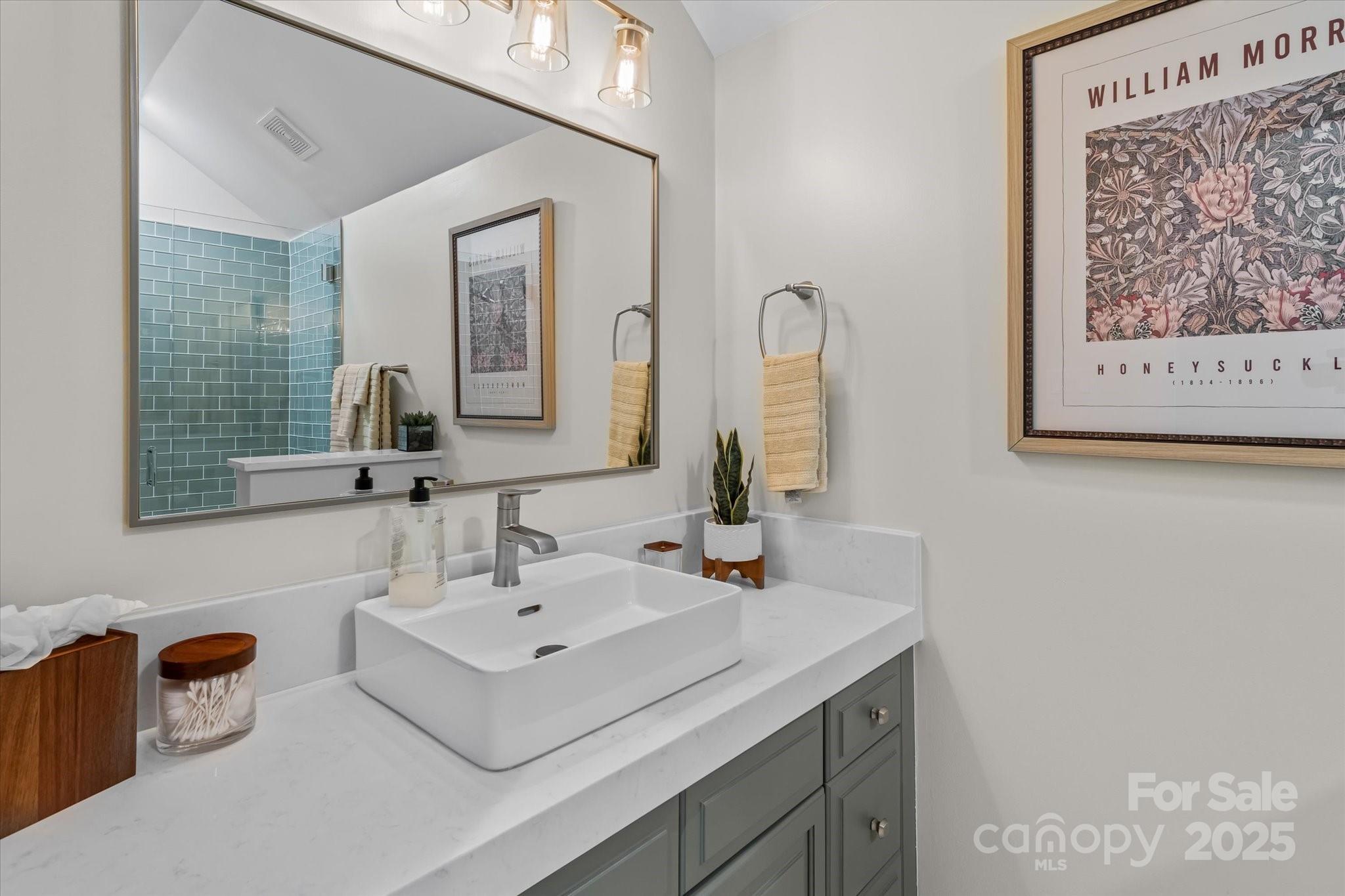 18916 Riverwind Lane Davidson, NC 28036 - Photo 28 of 38 a bathroom with a sink and a mirror