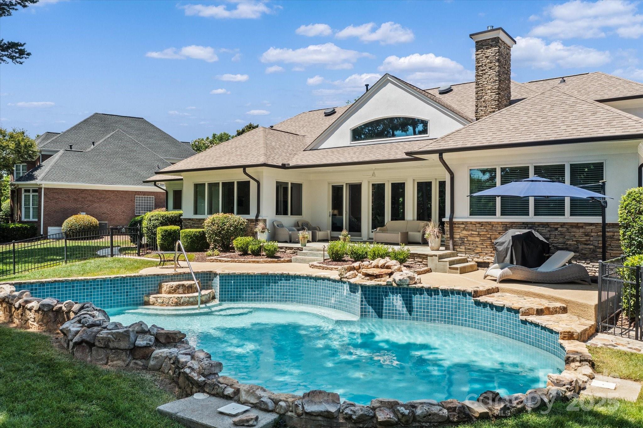 18916 Riverwind Lane Davidson, NC 28036 - Photo 32 of 38 a view of a house with backyard swimming pool and sitting area