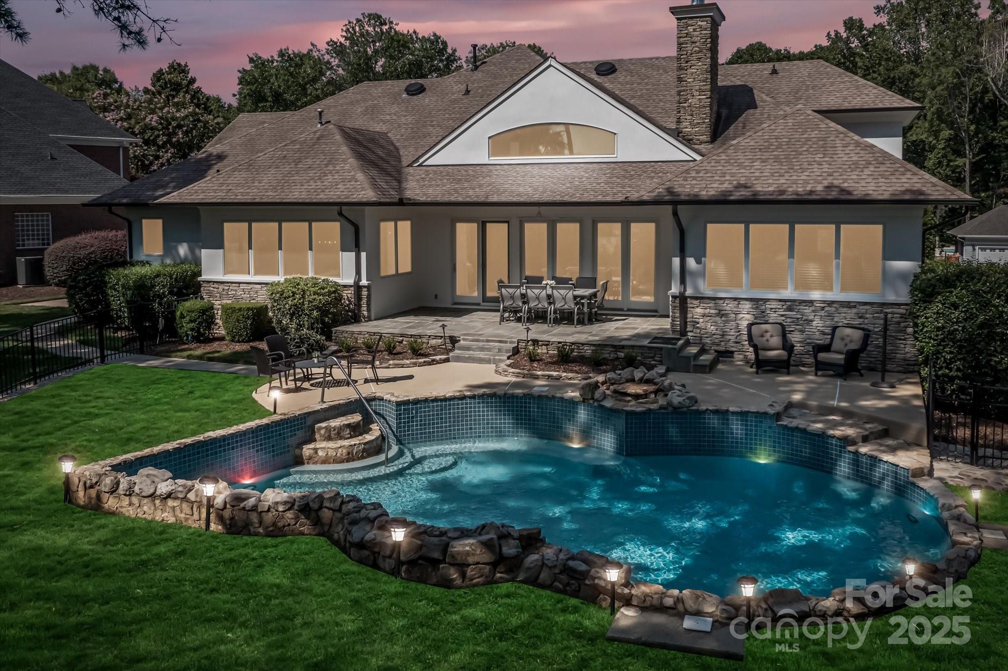 18916 Riverwind Lane Davidson, NC 28036 - Photo 34 of 38 a view of a house with backyard swimming pool and sitting area