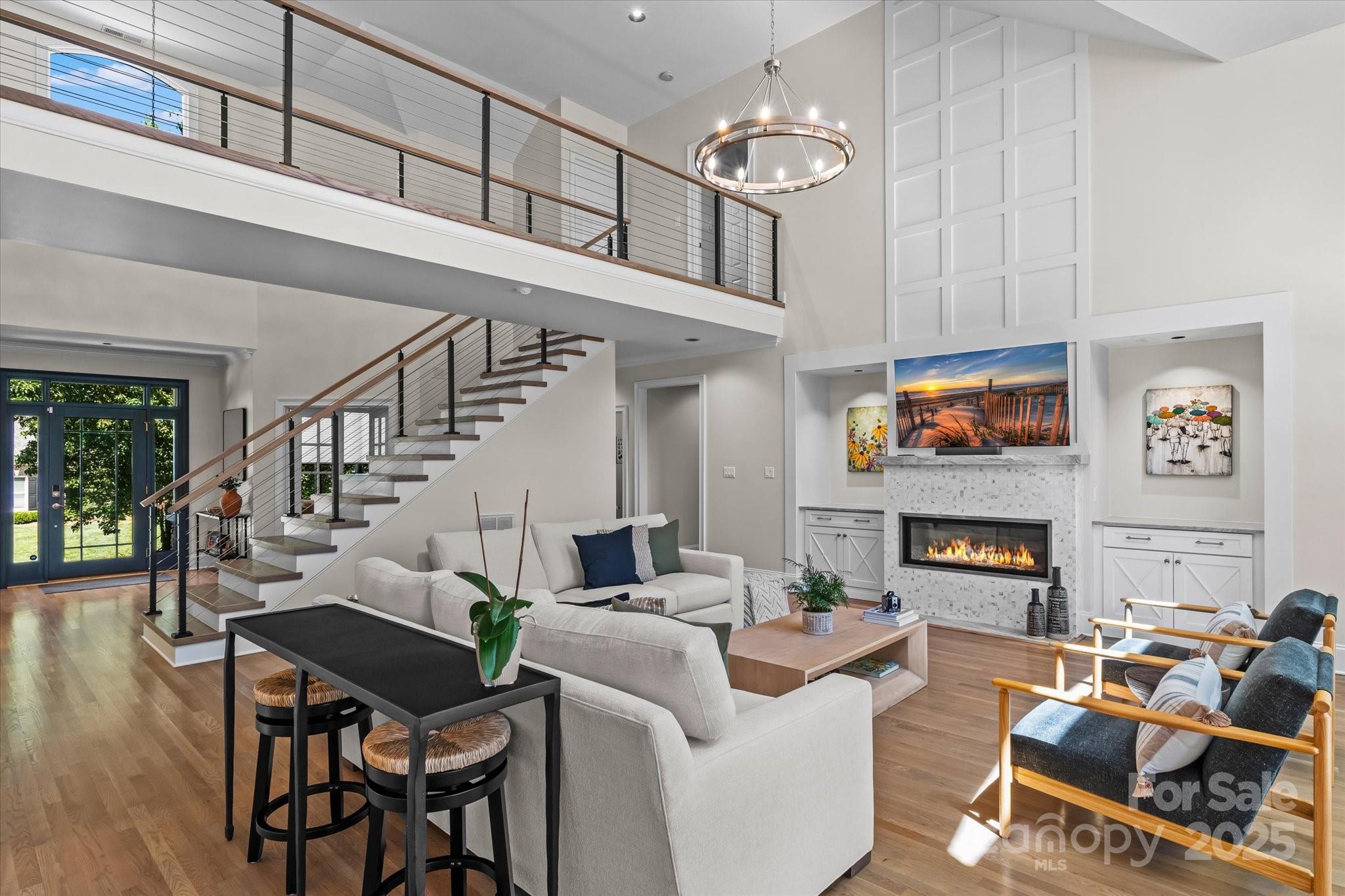 18916 Riverwind Lane Davidson, NC 28036 - Photo 7 of 38 a living room with fireplace furniture and a chandelier