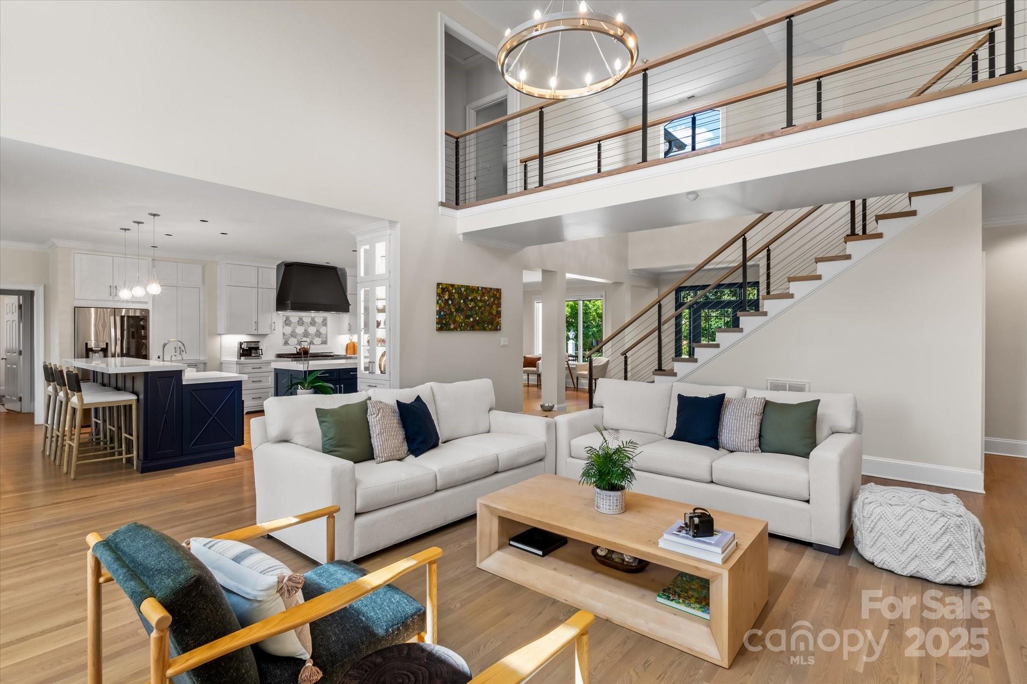 18916 Riverwind Lane Davidson, NC 28036 - Photo 8 of 38 a living room with furniture kitchen view and a chandelier