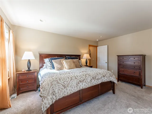 a bedroom with a bed and lamp