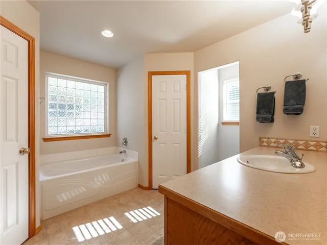 a bathroom with a sink a bathtub and a shower