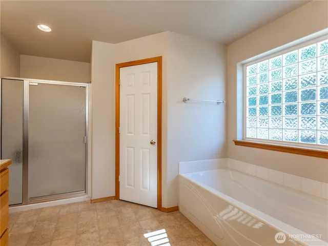 a bathroom with a bathtub and a shower