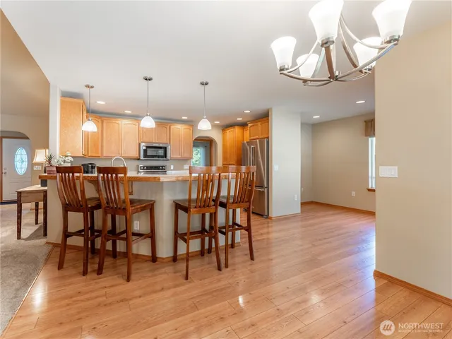 a view of a dining room with furniture and wooden floor