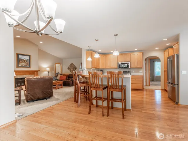 a living room with lots of furniture and kitchen view