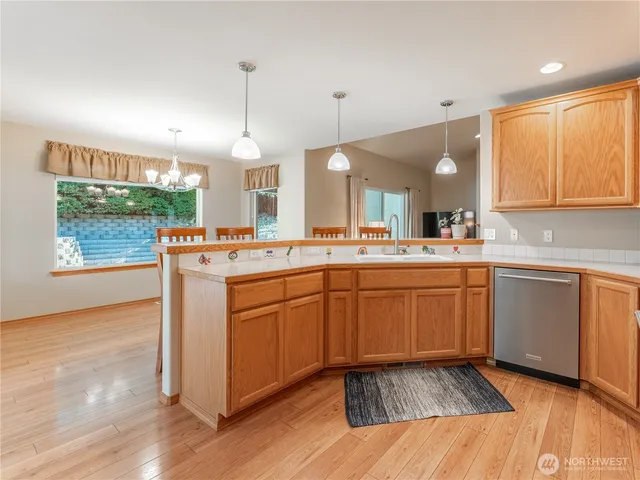 a kitchen with sink cabinets and wooden floor