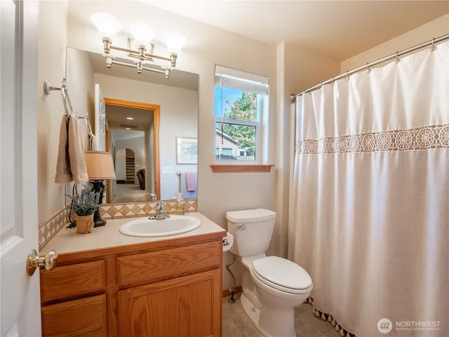 a bathroom with a toilet a sink and a mirror