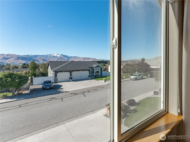 a view of a house with a floor to ceiling window and a balcony