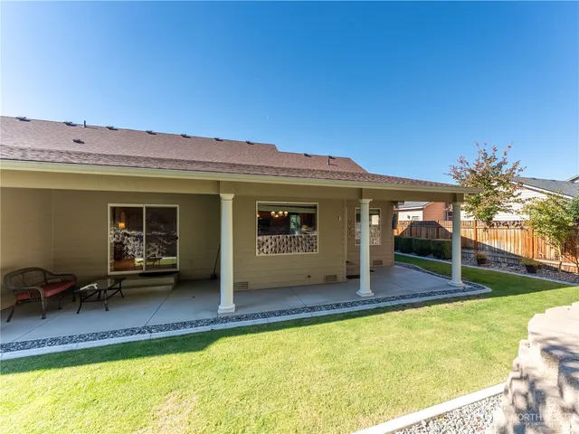 a view of a house with swimming pool and sitting area