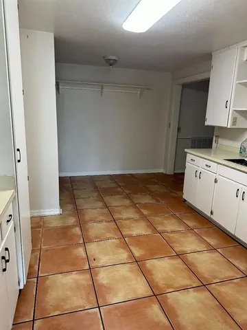 a kitchen with a sink a stove a refrigerator and cabinets
