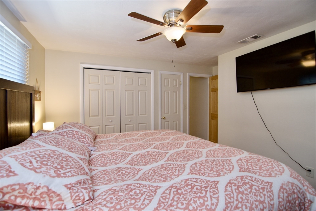 1070 Plumtree Road Springfield, MA 01119 - Photo 22 of 40 a bedroom with a bed and a flat screen tv