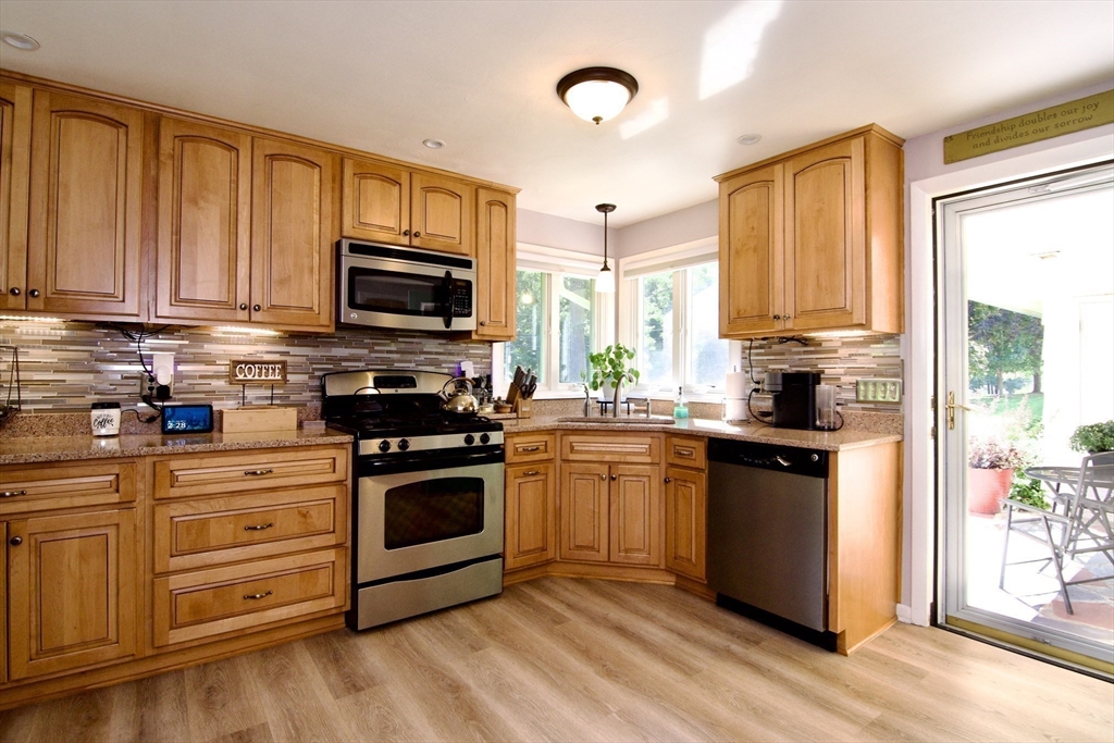 1070 Plumtree Road Springfield, MA 01119 - Photo 9 of 40 a kitchen with stainless steel appliances granite countertop a stove a sink and a refrigerator