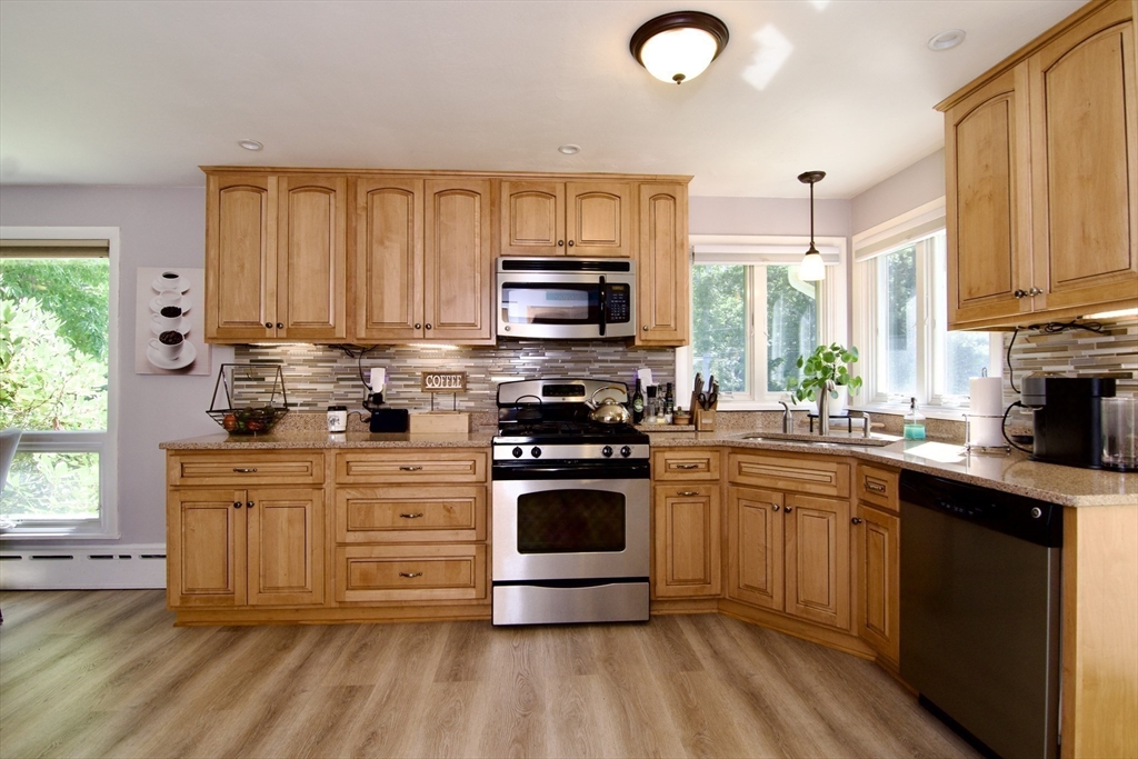 1070 Plumtree Road Springfield, MA 01119 - Photo 10 of 40 a kitchen with stainless steel appliances a stove sink microwave and cabinets