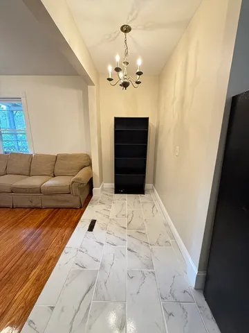 a living room with furniture a bathtub and a chandelier