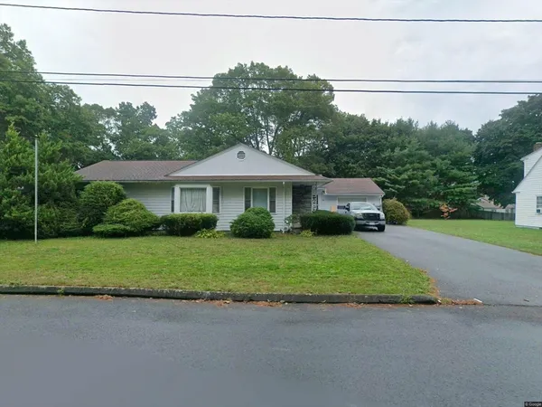 a front view of a house with a garden and pathway