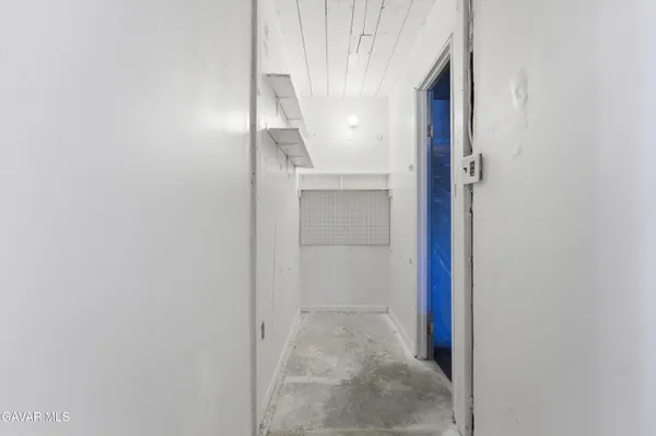 an empty room with a chandelier fan