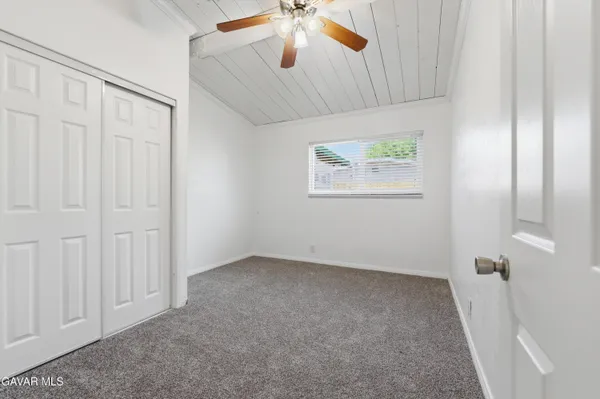 an empty room with windows and closet