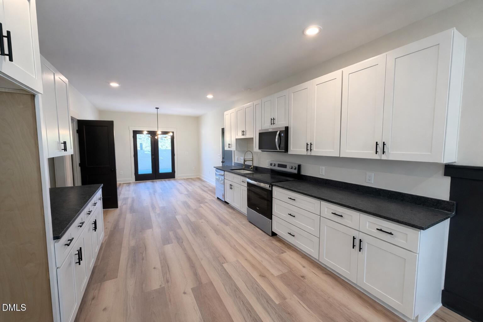 444 Park Springs Road Providence, NC 27315 - Photo 4 of 10 a kitchen with stainless steel appliances a refrigerator sink and cabinets