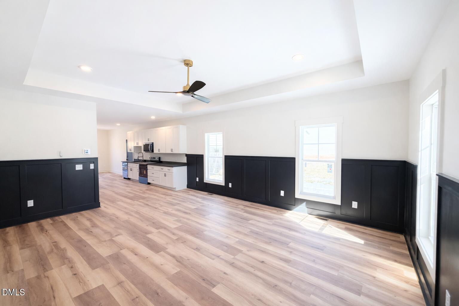 444 Park Springs Road Providence, NC 27315 - Photo 5 of 10 a view of kitchen and empty room with wooden floor