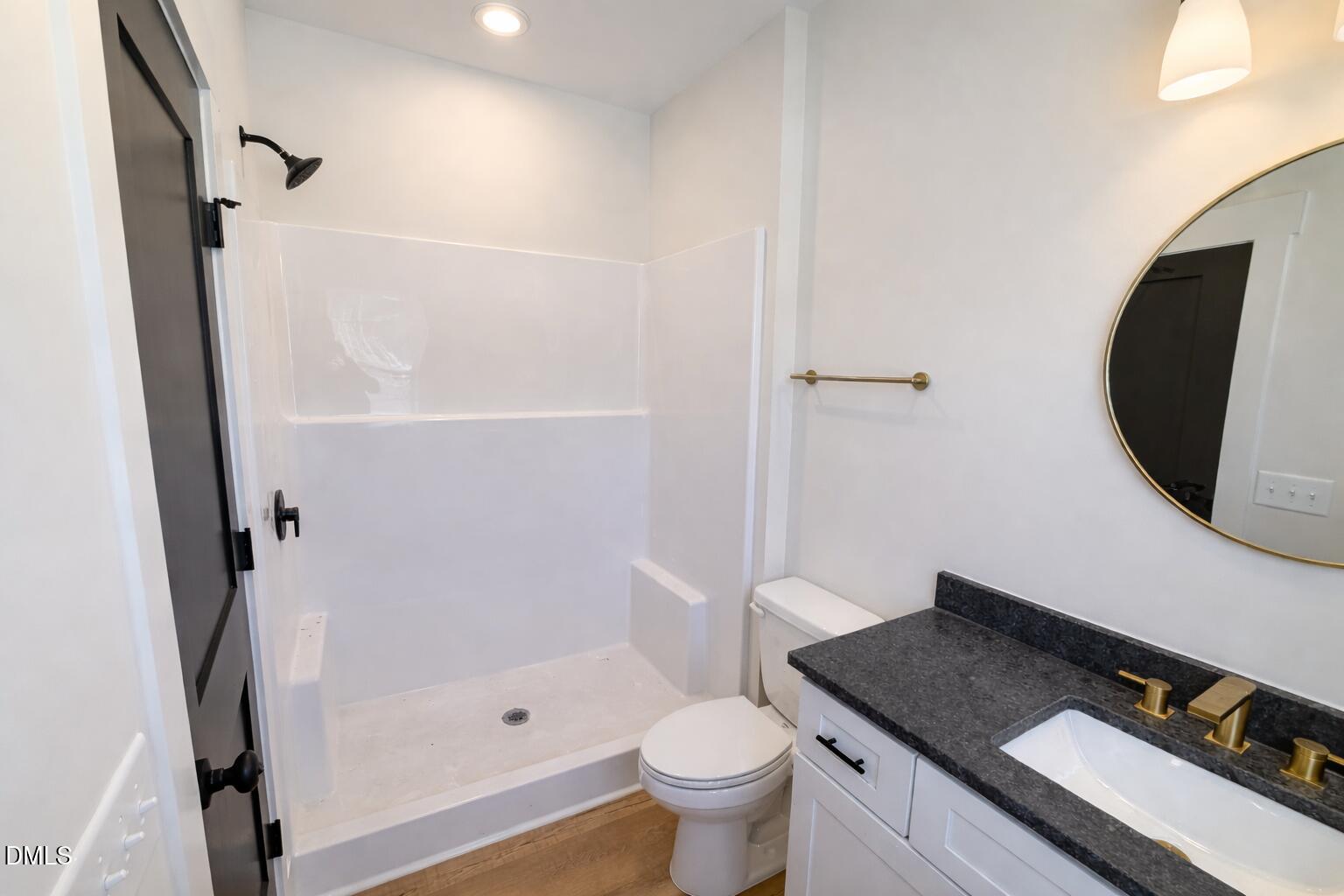 444 Park Springs Road Providence, NC 27315 - Photo 9 of 10 a bathroom with a granite countertop sink toilet and shower
