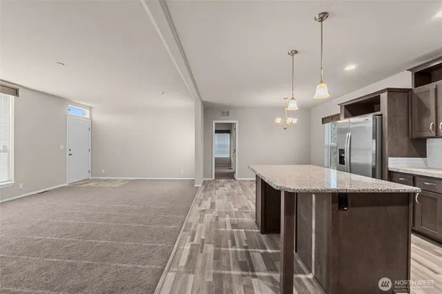 a view of a kitchen with a sink and microwave