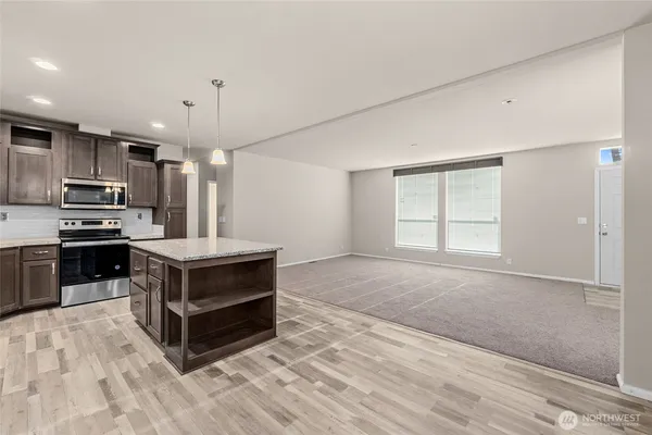 a kitchen with stainless steel appliances a stove and a refrigerator