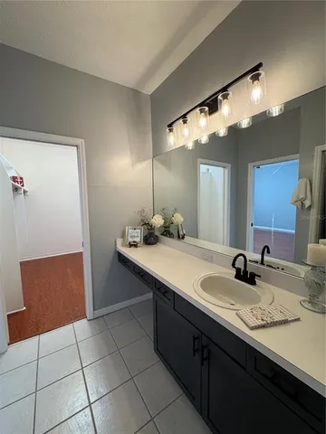 a bathroom with a sink a vanity and a mirror