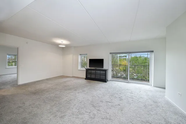 a view of a livingroom with an empty space and a fireplace