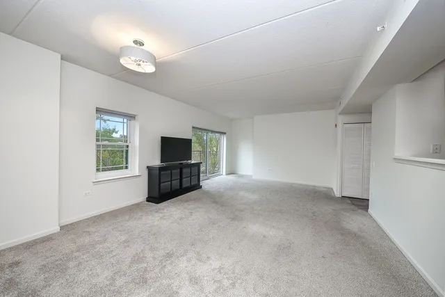 a view of a livingroom with furniture and a flat screen tv