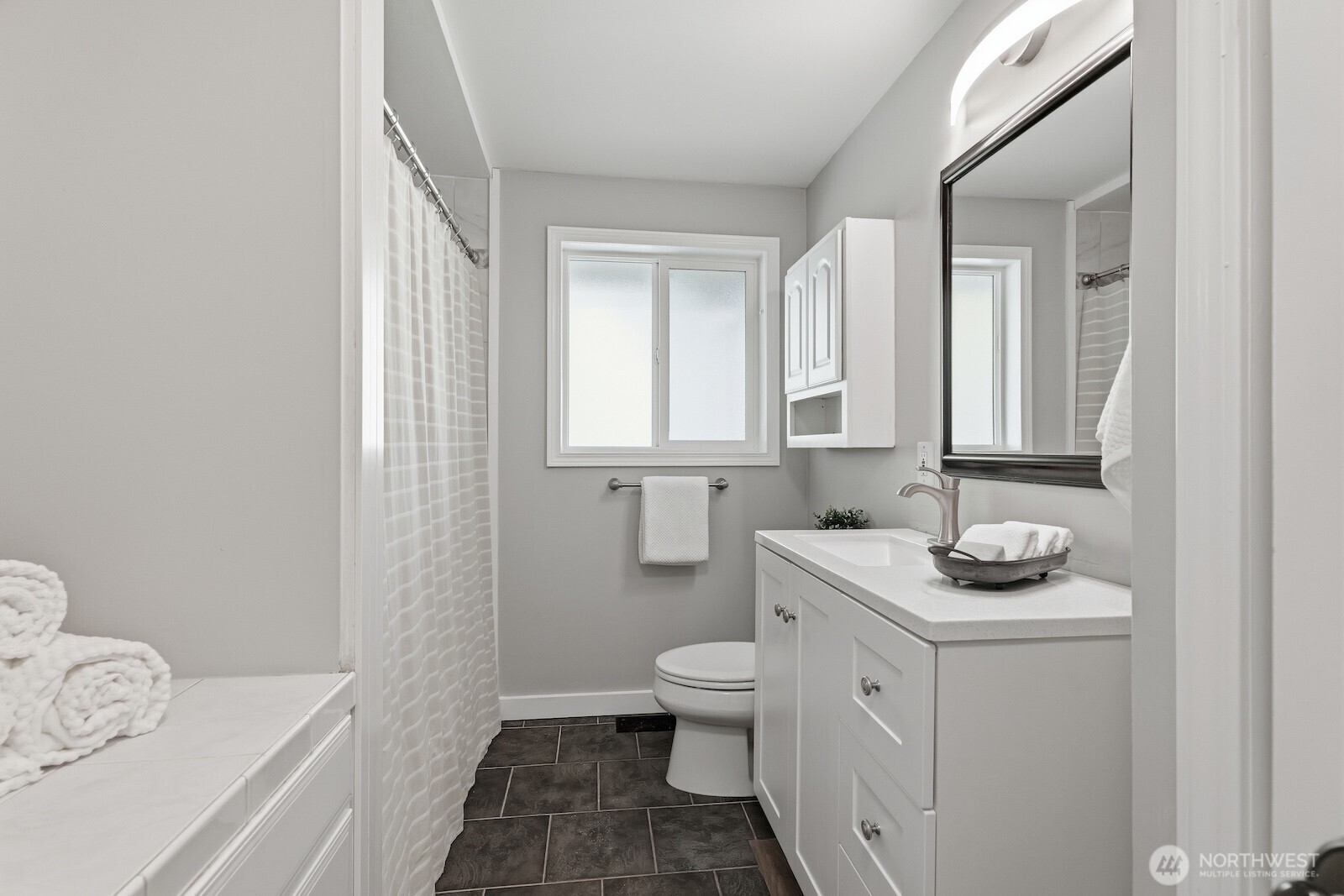 11617 Fay Road Northeast Carnation, WA 98014 - Photo 20 of 40 a bathroom with a granite countertop sink a toilet and a mirror
