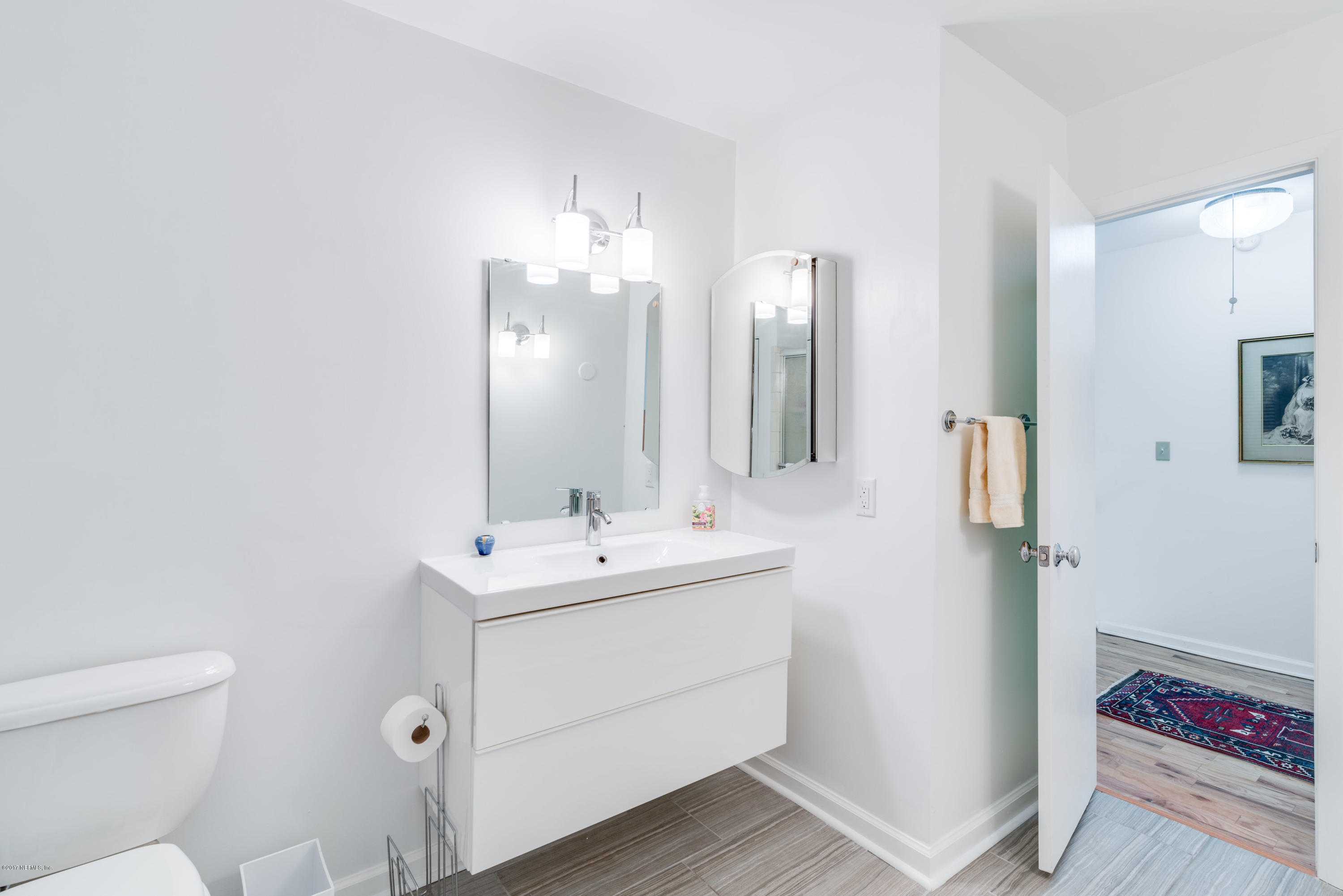 2233 Seminole Road, Unit 1 Atlantic Beach, FL 32233 - Photo 11 of 35 a bathroom with a double vanity sink and a mirror