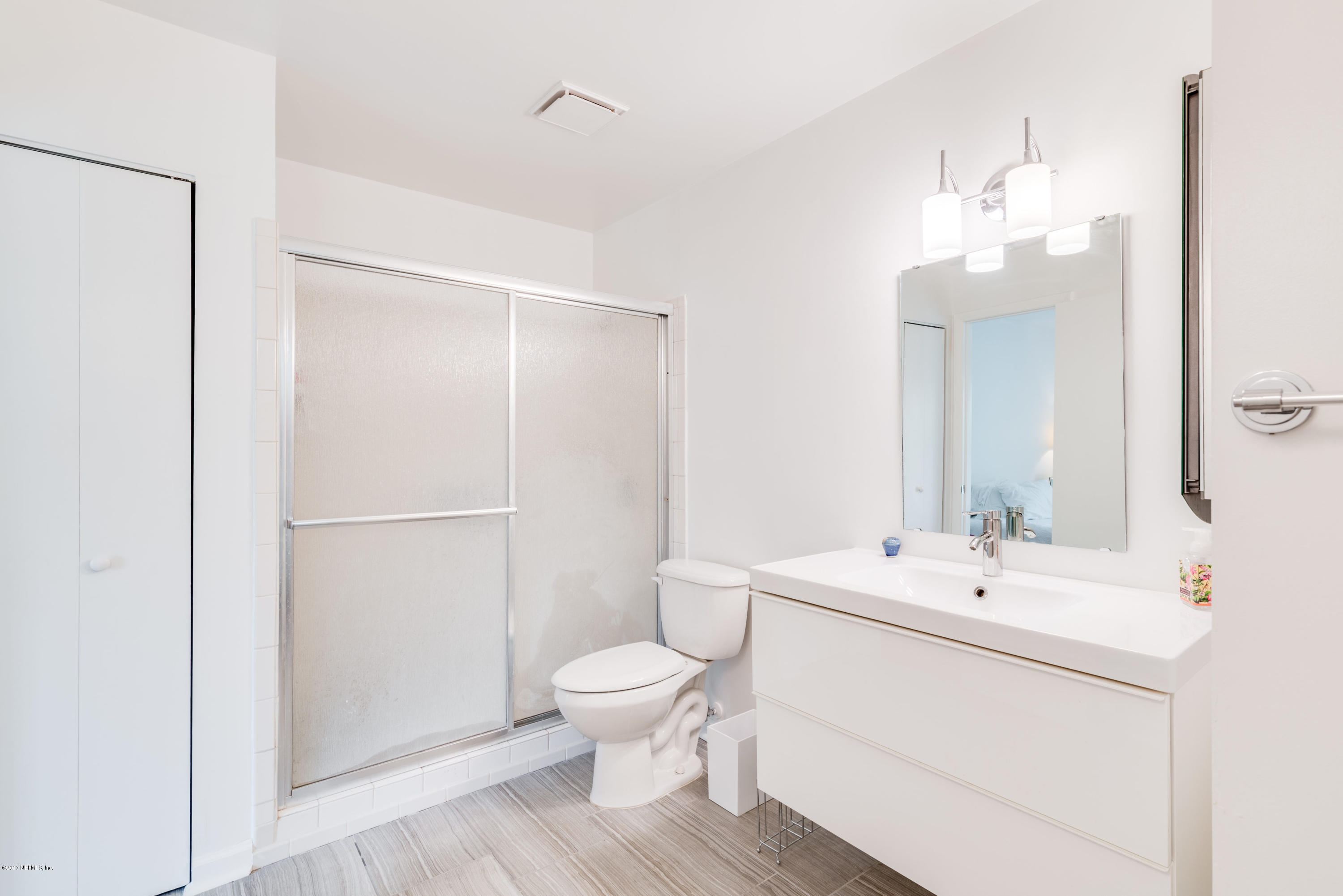 2233 Seminole Road, Unit 1 Atlantic Beach, FL 32233 - Photo 12 of 35 a bathroom with a toilet a sink and a mirror