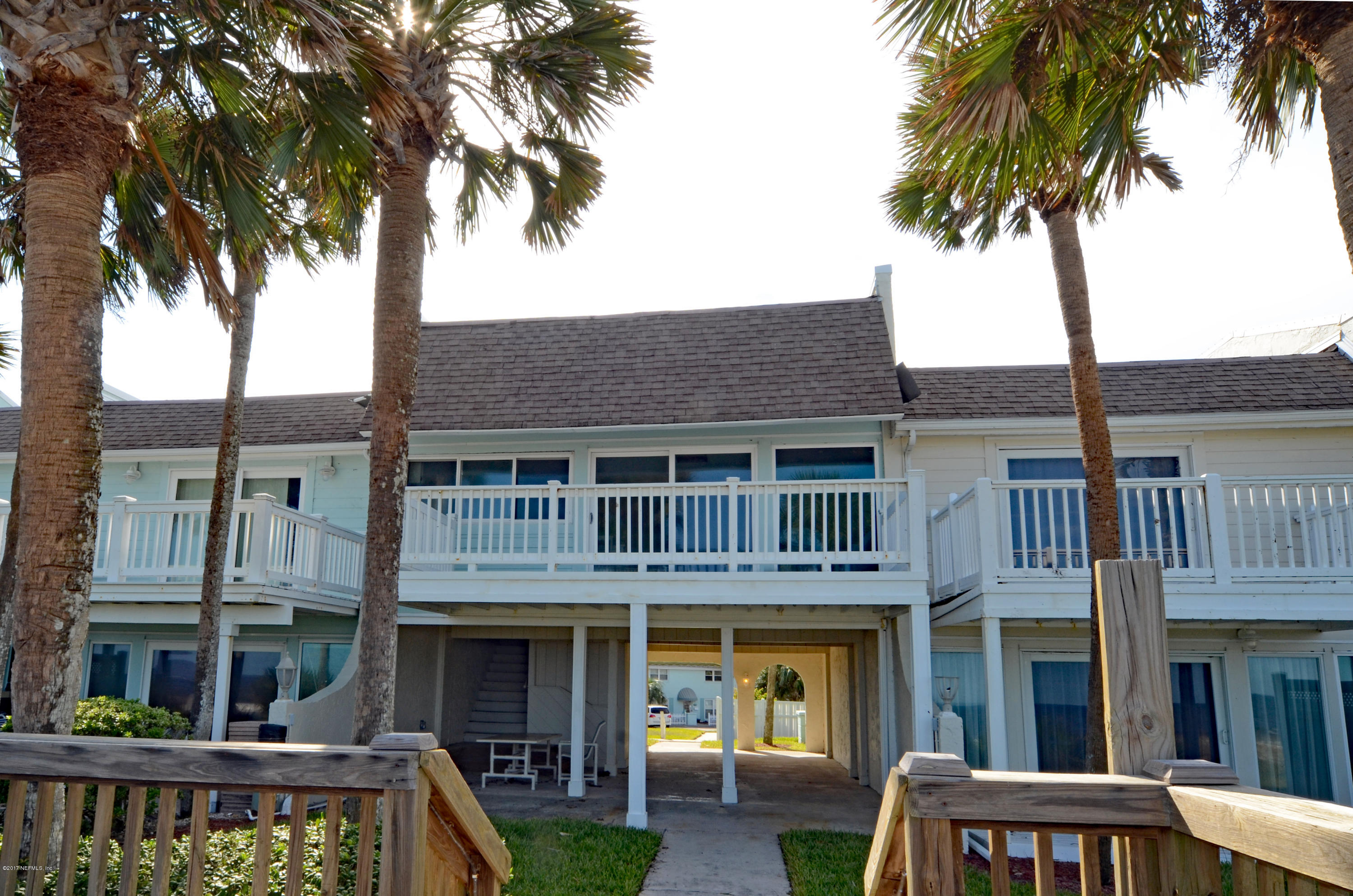2233 Seminole Road, Unit 1 Atlantic Beach, FL 32233 - Photo 21 of 35 a front view of a building with a garden and trees