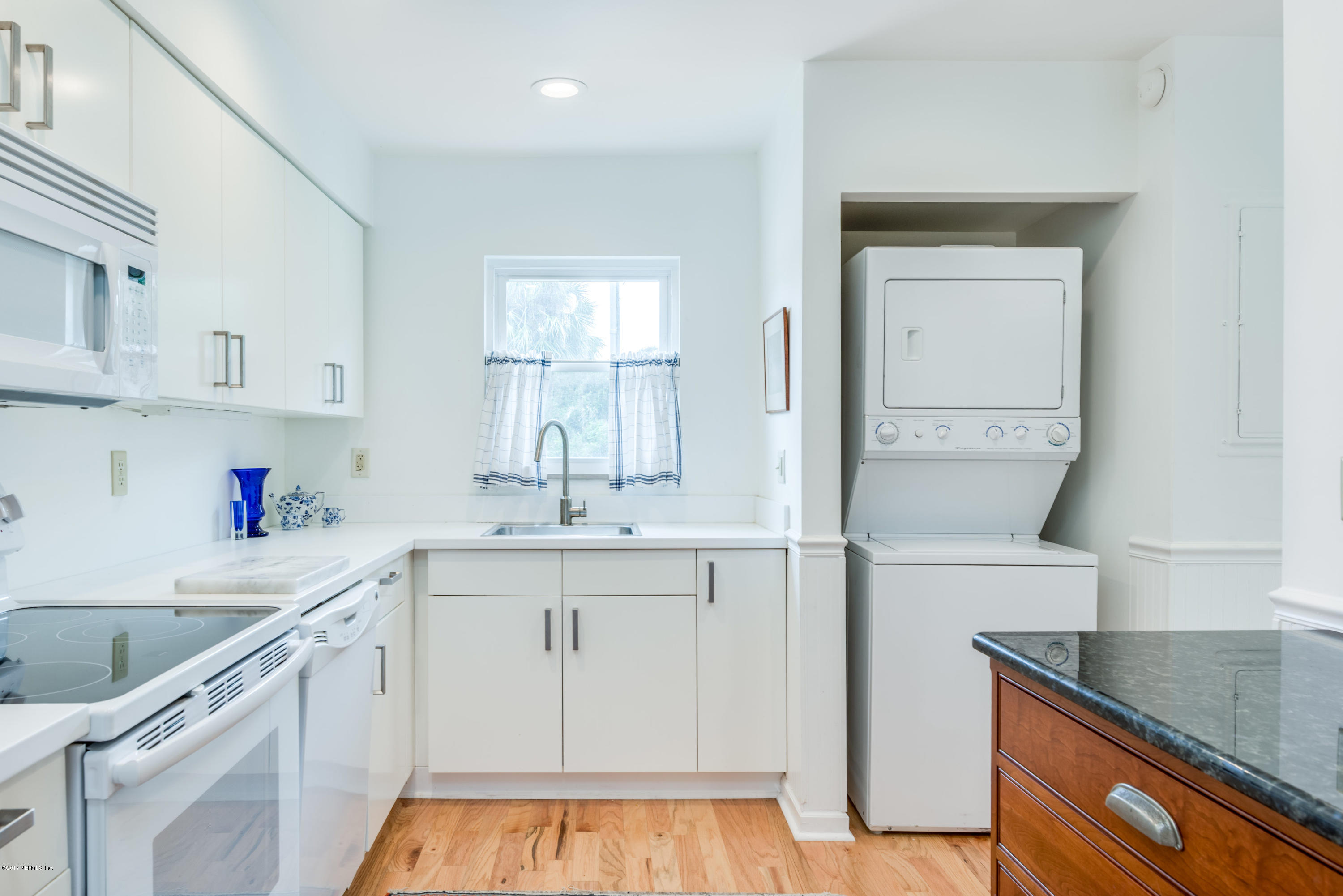 2233 Seminole Road, Unit 1 Atlantic Beach, FL 32233 - Photo 6 of 35 a kitchen with a sink cabinets and window