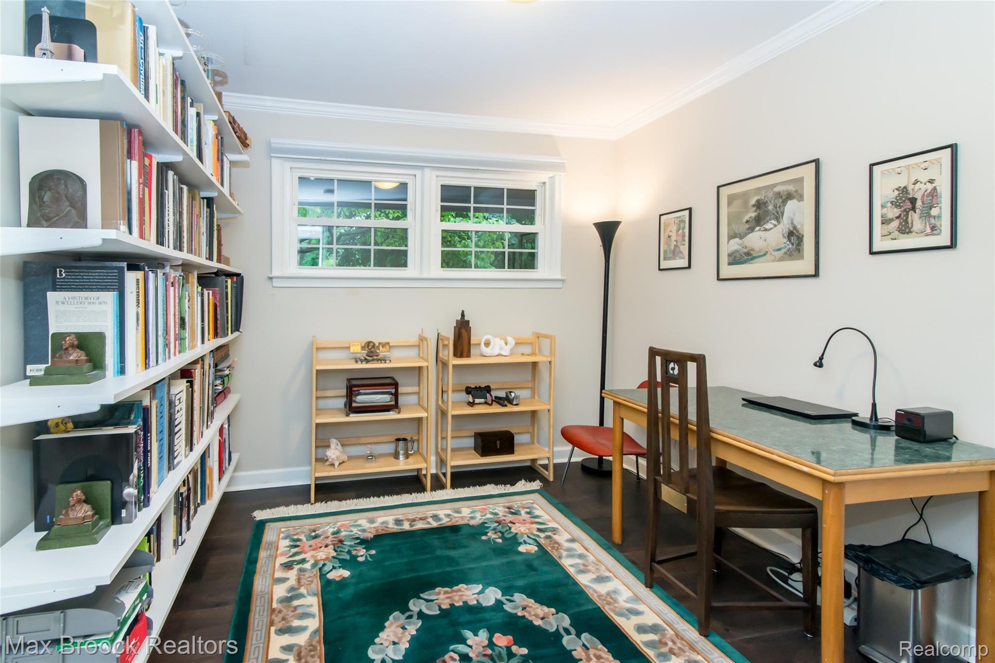 6799 East Dartmoor Road West Bloomfield, MI 48322 - Photo 19 of 36 Room featuring extensive built-in shelving, crown molding, double casement windows, wood-finish flooring, and a ceiling light fixture